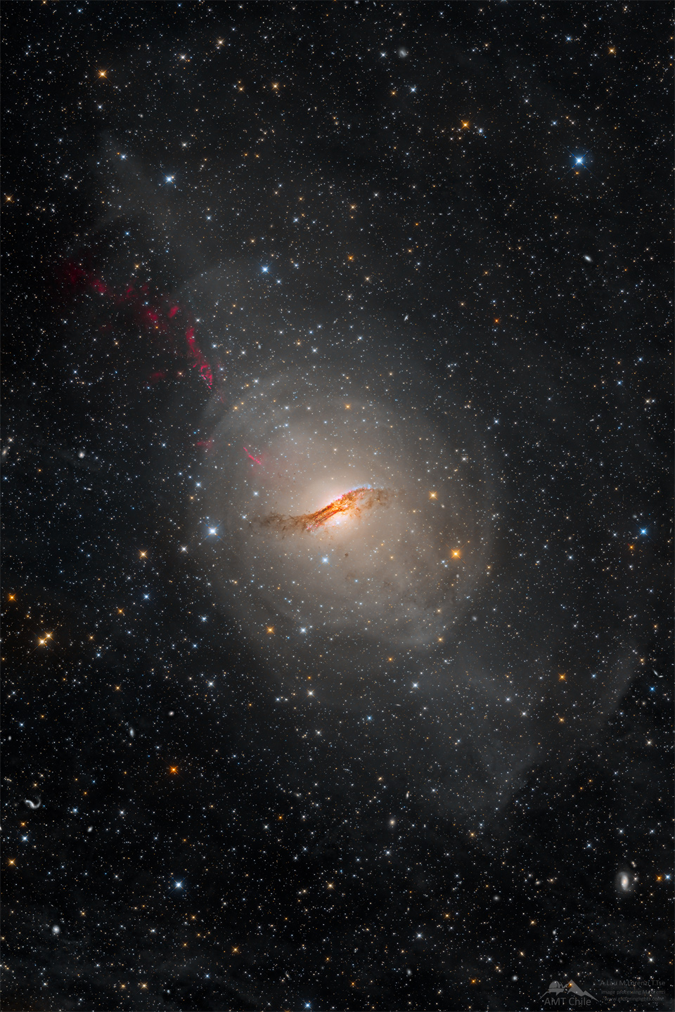 A long duration image of the unusual galaxy Centaurus A.
The galaxy appears as a light oval with a complex dark dust
lane running across its centre. A starfield surrounds the galaxy.
Please see the explanation for more detailed information.