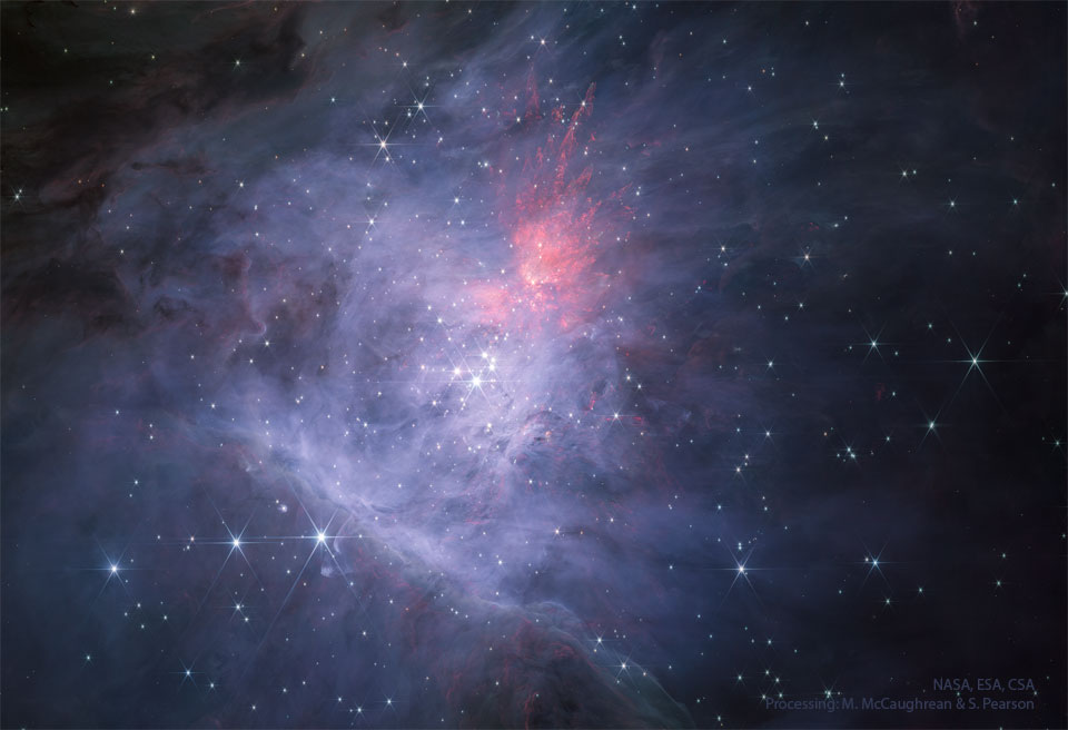 The centre of the Orion Nebula is seen in infrared light
as imaged by the James Webb Space Telescope. In the centre is
the Trapezium Star Cluster. The main image is in near infrared
light, while the rollover image is in mid-infrared light.
Please see the explanation for more detailed information.