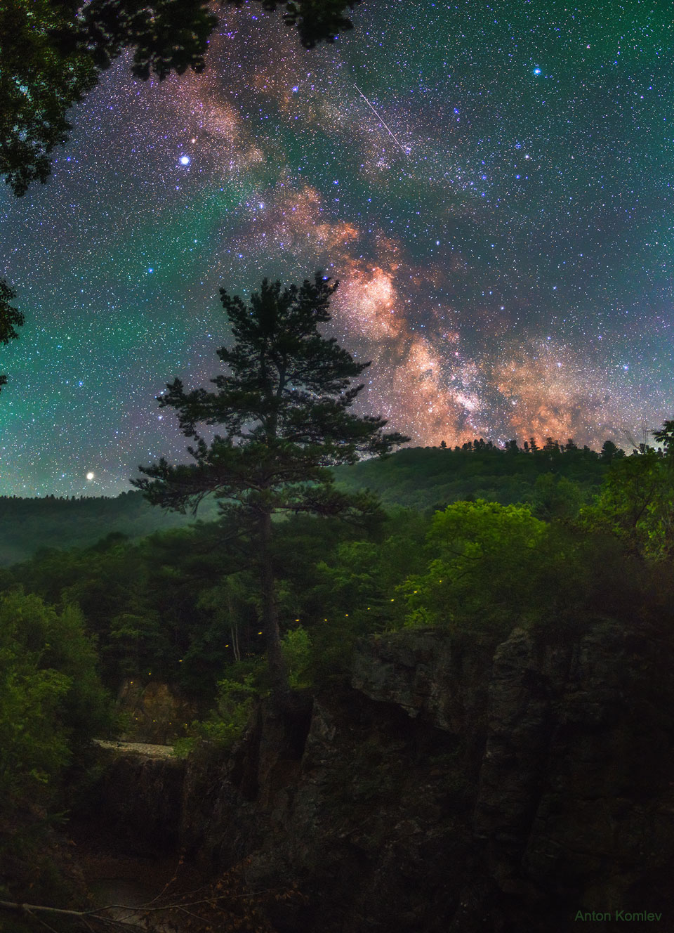 The picture shows an arching Milky Way Galaxy with a firefly 
path in the foreground over Russia.
Please see the explanation for more detailed information.