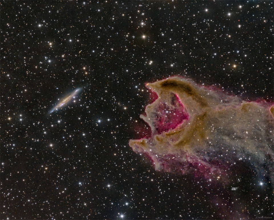 The featured image shows a distant galaxy on the left next to a 
gas cloud on the right. An opening in the gas cloud is on the same side
as the galaxy.
Please see the explanation for more detailed information.