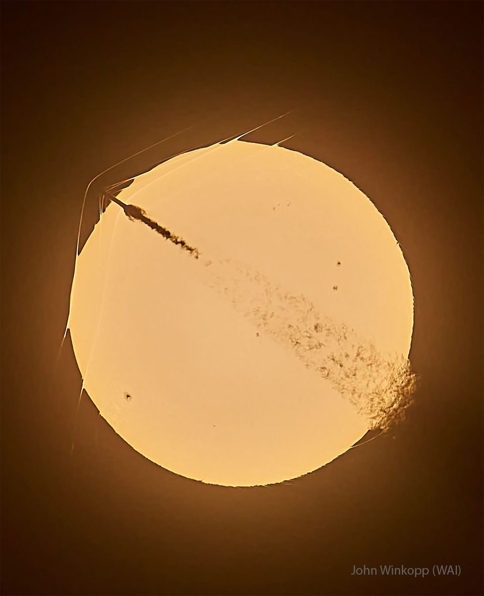 The disk of the Sun is shown with a rocket launching
through it. The rising rocket shows a plume behind it and
three unusual waves curve around its top tip.
Please see the explanation for more detailed information.