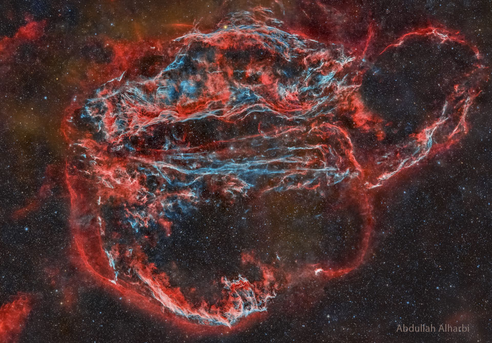 The featured image shows a night sky with a large
complex nebula in red and blue. The Veil Nebula has several famous
components such as the Bat and Witch's Broom Nebulae. 
Please see the explanation for more detailed information.