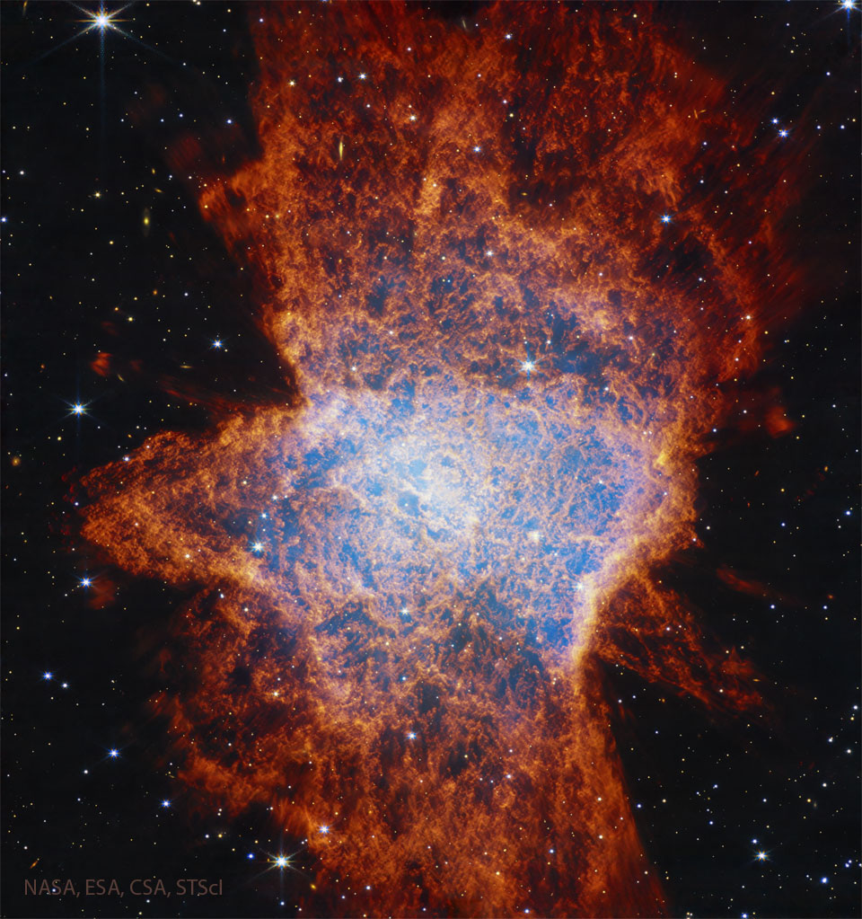 A starfield is shown dominated by a complex
nebula shown with many red filaments and with a
light glow in a region near the centre. 
Please see the explanation for more detailed information.