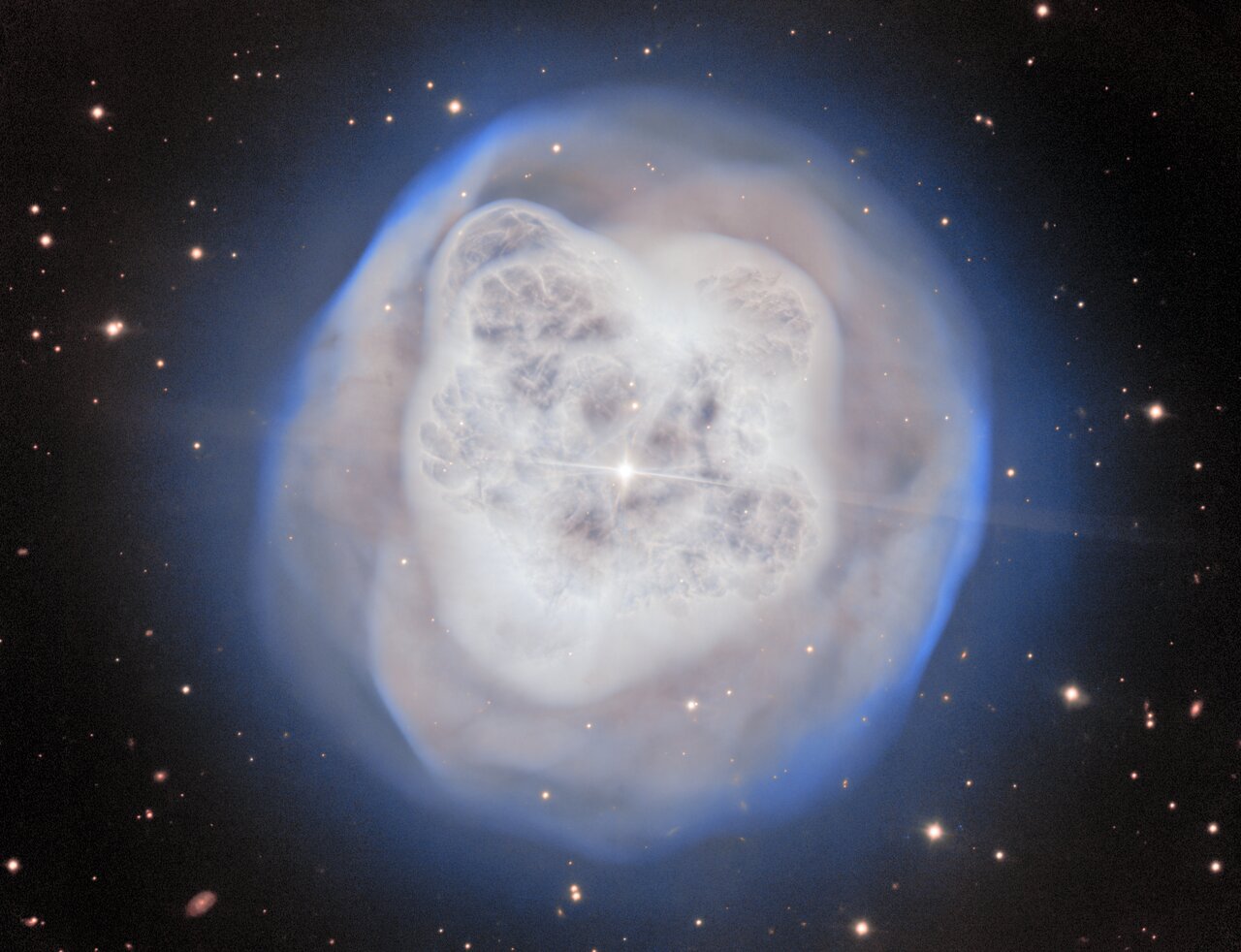 A white nebula over a black background with a
	  bright star in the centre.